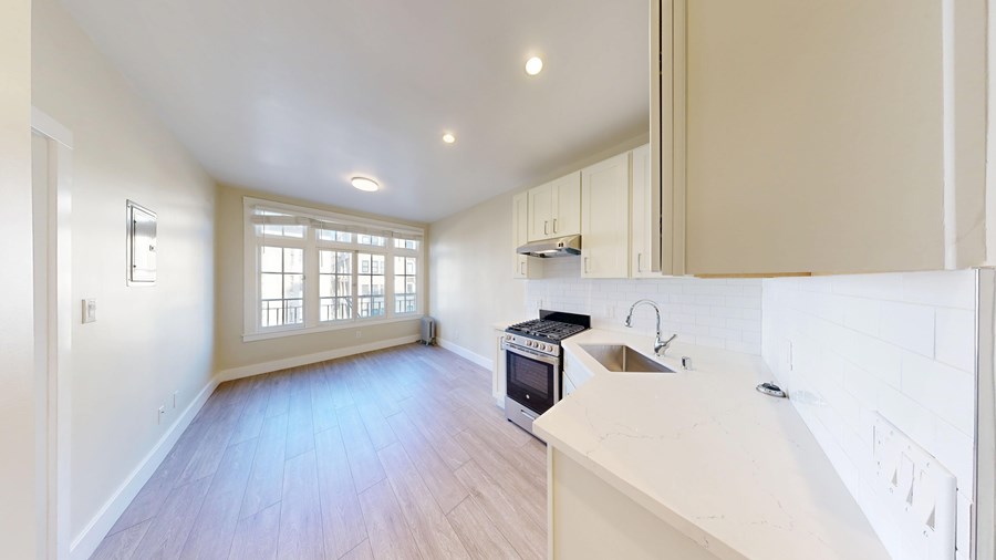 A kitchen with a microwave on the counter.